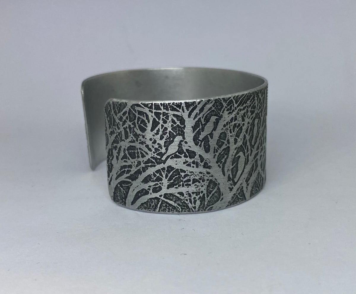 Beautiful aluminium cuff featuring Rooks in a Forest- hand etched by Anna Roebuck from her original illustration.